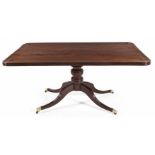 A REGENCY MAHOGANY BREAKFAST TABLE the rectangular top with reeded frieze, on a turned support on