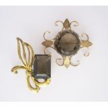 TWO SMOKY QUARTZ BROOCHES one claw set with a circular mixed-cut smoky quartz weighing approximately