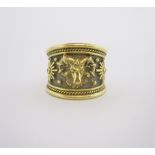 AN 18CT GOLD 'ZODIAC' (ARIES) RING, ELIZABETH GAGE the broad tapered band with ram's mask raised