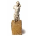 A CONTINENTAL CARVED IVORY FRAGMENT FIGURE OF SAINT SEBASTIAN NOT SUITABLE FOR EXPORT raised on a