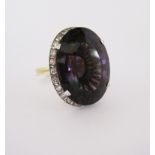 AN AMETHYST AND DIAMOND RING claw set to the centre with an oval mixed-cut amethyst weighing