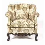 A MAHOGANY AND UPHOLSTERED ARMCHAIR, 19TH CENTURY the padded back between padded sides, stuff-over