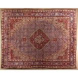 A TABRIZ CARPET,NORTH WEST PERSIA,MODERN the indigo-blue field with a red and ivory floral