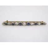 A CASED DIAMOND AND SAPPHIRE BAR BROOCH designed as a tapered line of old-cut diamonds alternating