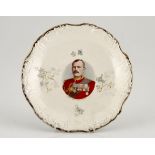 Anglo-Boer War Souvenir Plate 1900 Diameter: 24cm. A gold edged white china plate with a coloured