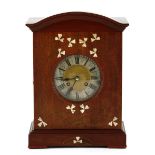 An Arts and Crafts Clock, late 19th Century with mother of pearl inlay, eight day movement and