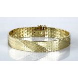 A 14CT GOLD BRACELET composed of flat links, with a diagonal satin and polished design, impressed