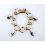 AN 18CT GOLD BRACELET composed of circular and bar links, applied with four "gem babies", with
