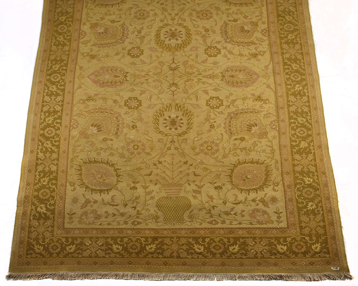 AN INDO PERSIAN FLATWEAVE CARPET the pale gold field with an overall design of palmette and vine