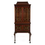 A CHIPPENDALE STYLE MAHOGANY DISPLAY CABINET the pagoda-shaped pediment above a fretwork-carved