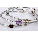 THREE SILVER AND GEMSTONE BANGLES each bangle tube-set with various gemstones including: amethyst,