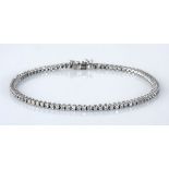 A DIAMOND TENNIS BRACELET claw-set with eighty-eight round brilliant-cut diamonds weighing