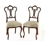 A PAIR OF VICTORIAN WALNUT SIDE CHAIRS, LATE 19TH CENTURY each arched top rail above a pierced and
