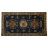 AN INDO PERSIAN RUG, MODERN the blue field with three round medallions depicted in pale brown and