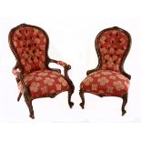 A VICTORIAN WALNUT GRANDFATHER CHAIR the curved button-back within a conforming frame centred by a