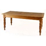 AN OAK TABLE the moulded rectangular top above a plain frieze, on ring-turned tapering legs 77cm
