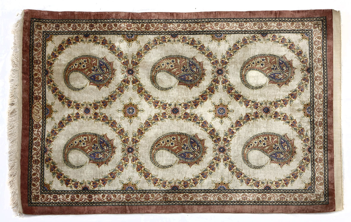 A QUM SILK RUG, PERSIA, MODERN the ivory field with two rows of three round medallions with rose “