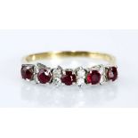 A RUBY AND DIAMOND RING claw-set with five round rubies weighing approximately 0.75cts in total,