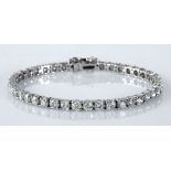 A DIAMOND TENNIS BRACELET claw set with forty-two round brilliant-cut diamonds weighing