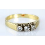 A THREE STONE DIAMOND RING claw-set with round brilliant-cut diamonds weighing approximately 0.24cts