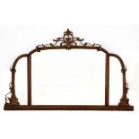 A VICTORIAN MAHOGANY SIDEBOARD MIRROR the shaped plate within a conforming frame centred by a