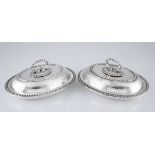 A PAIR OF ELECTROPLATE ENTREE DISHES each of ovoid form, with bright-cut and foliage decoration, the
