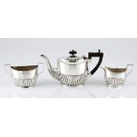 AN EDWARDIAN SILVER TEA SET, WILLIAMS LTD., BIRMINGHAM, comprising: a teapot, a milk jug and a two-