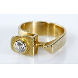 A DIAMOND RING, ERICH FREY of stylised design with a plain flat tapered band concluding in