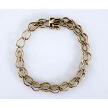A 14CT GOLD BRACELET comprised of plain stylised U-shaped links centred with a twist rope design,
