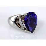 A TANZANITE AND DIAMOND RING claw-set with a pear-shaped tanzanite weighing 9.0cts, the gallery
