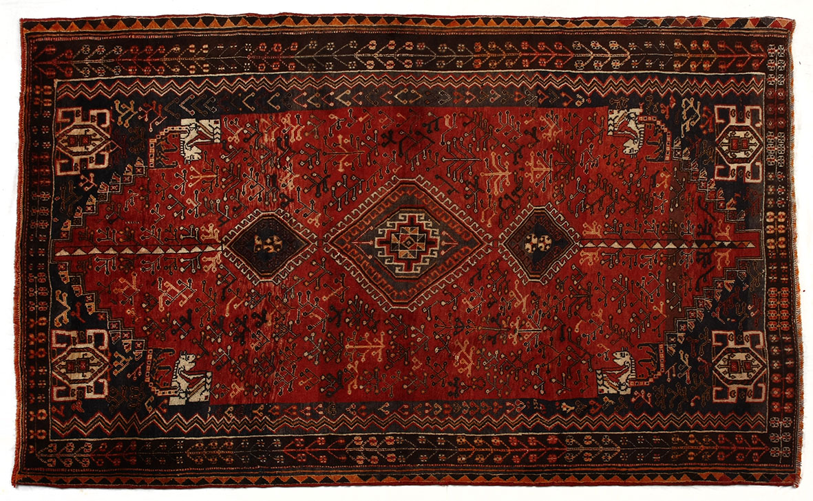 A KASHGHAI RUG, SOUTH WEST PERSIA, MODERN the red field with a hooked triple medallion all with