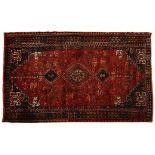 A KASHGHAI RUG, SOUTH WEST PERSIA, MODERN the red field with a hooked triple medallion all with