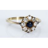 A SAPPHIRE AND DIAMOND RING designed as a flowerhead cluster, centred with a round mixed-cut