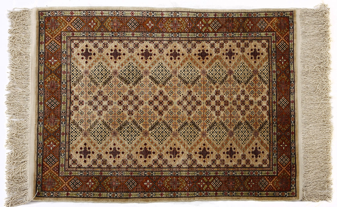 A HEREKE SILK PRAYER RUG, TURKEY, MODERN the ivory field with an overall design of geometric