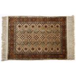 A HEREKE SILK PRAYER RUG, TURKEY, MODERN the ivory field with an overall design of geometric