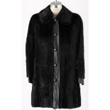 A BLACK MINK AND LEATHER COAT An elegant vintage fur coat with leather lapel, round pockets and side