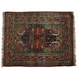 AN INDO-PERSIAN RUG, MODERN the green field with two Caucasian medallion depicted in blue and red