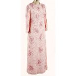 A PINK BEADED EVENING GOWN A stunning floor-length gown with long sleeves. Covered in beads,