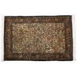 A QUM SILK RUG, PERSIA, MODERN the pale gold field with a one directional design of flowering