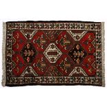 A BAKTIARI RUG, PERSIA, MODERN the field divided into diamond medallion depicted in red, blue and