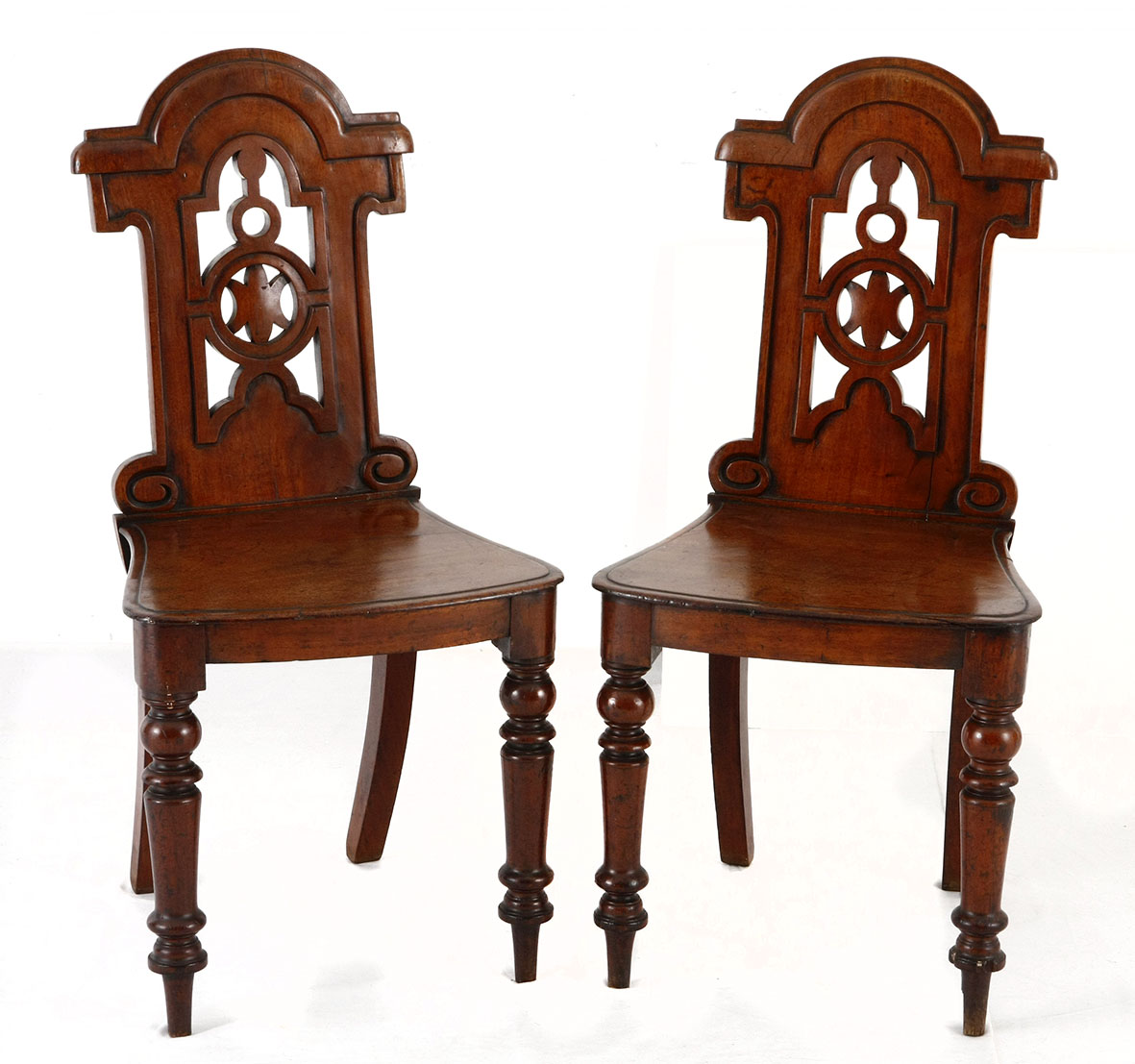 A PAIR OF WILLIAM IV MAHOGANY CHAIRS each with a moulded arched top rail above a pierced splat,