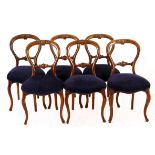 A SET OF SIX WALNUT BALLOON-BACK CHAIRS, 19TH CENTURY each top rail centred by a carved cresting