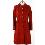 A VINTAGE SUEDE COAT An outstanding vintage piece in rust suede. 6 gold buttons down the front.