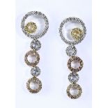 A PAIR OF DIAMOND EARRINGS each designed as an articulated line of circles of varying sizes, set