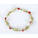 A 14CT GOLD BRACELET comprising of alternating links of gold elephants and glass beads, impressed