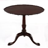 A GEORGIAN MAHOGANY TILT-TOP OCCASIONAL TABLE the circular hinged top on a turned support, on