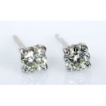 A PAIR OF DIAMOND EAR STUDS each claw-set with a round brilliant-cut diamond weighing