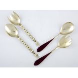 A PAIR OF NORWEIGEN SILVER-GILT AND ENAMEL SALAD SERVERS each stylised handle with yellow coloured