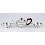 A GEORGE V SILVER TEA SET, WALKER & HALL, BIRMINGHAM, comprising: a teapot, a milk jug and a two-