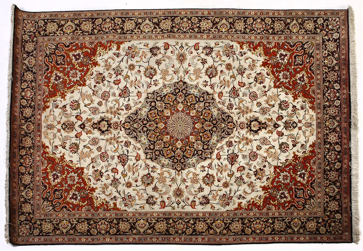 AN INDO PERSIAN SILK CARPET MODERN the ivory field with a deep blue floral medallion and pendant,